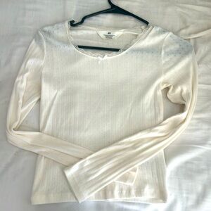 This is a H&M off-white long sleeve top with lace and bows